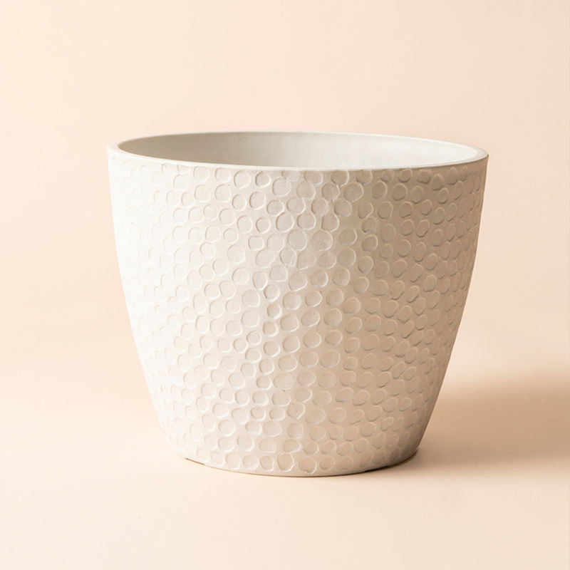 A full view of white planter with honeycomb pattern, made of recyclable plastic and stone powders.