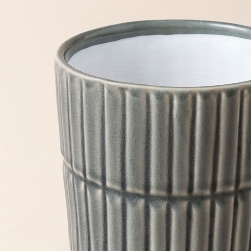 A close-up of the gray pot, showing its fully glazed finish and vertical tidy lines design features.