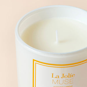 A close up of a Jasmine jarred candle showing its cotton wick.