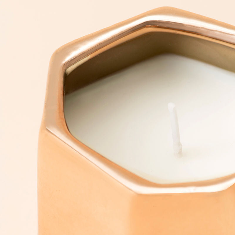 A close up of Jasmine and Ylang Ylang candle, showing its cotton wick.