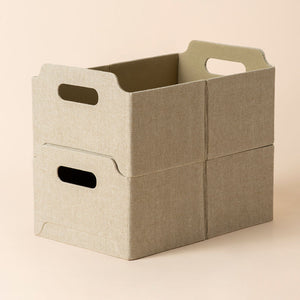 Two khaki rectangular baskets are displayed in a stacked position, showing its space-saving capacity.