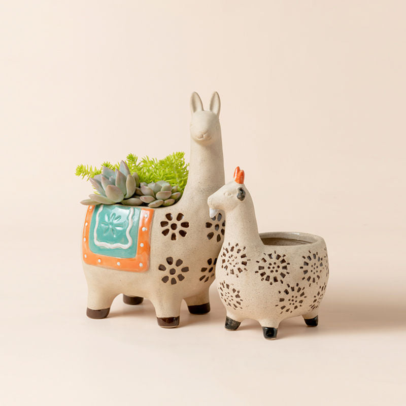A set of two different sizes planters for succulents. Pots are alpaca and goat-shaped with flower patterns decorated on the surface.
