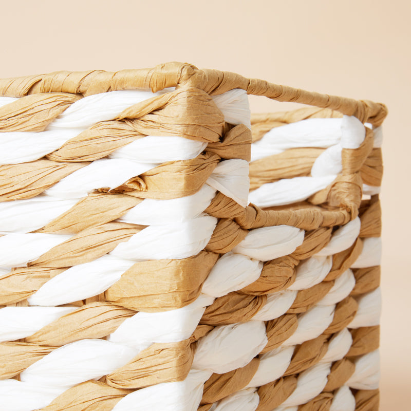 A close-up of the paper rope basket, showing its white and beige woven design pattern.