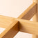 A close-up of the stand. It is formed by two pieces, the two wooden pieces made across to keep the stability of the stand.