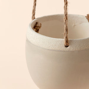 A close-up of the pot, showing its off-white unglazed rime and light gray surface.A close-up of the pot, showing its light brown unglazed rime and light gray surface.