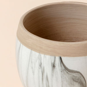 This zoomed-in picture of the smaller white and marble pots shows the detail of the sandy texture and the marble ink design.