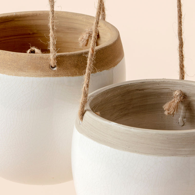 A close-up of the hanging planters set, showing its sturdy ropes and smooth rims.