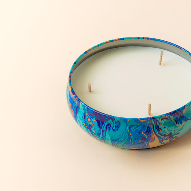 A close up of Citronella Scented candle, showing its three cotton wicks.