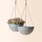 A set of two gray hanging planters with marble pattern, made from durable plastic and natural stone powders.