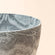 A close-up of a Nova Marble Pattern Pots, showing its waves marble design around exterior and interior and plastic feature.