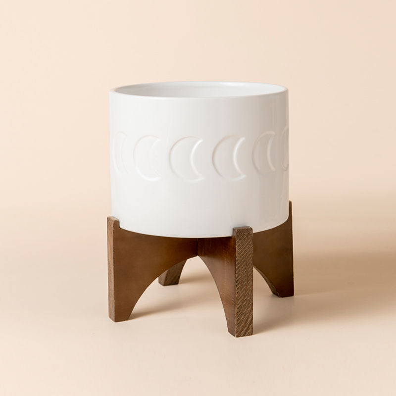 A full view of white planter with wooden stand, made of premium ceramic and fully glazed.