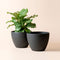 A set of two 11.3-inch black outdoor planter, made from recyclable plastic and natural stone powders.