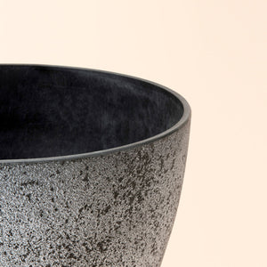 A close-up of nova rock grey pot, showing its rock-pattern design and smooth rim features.