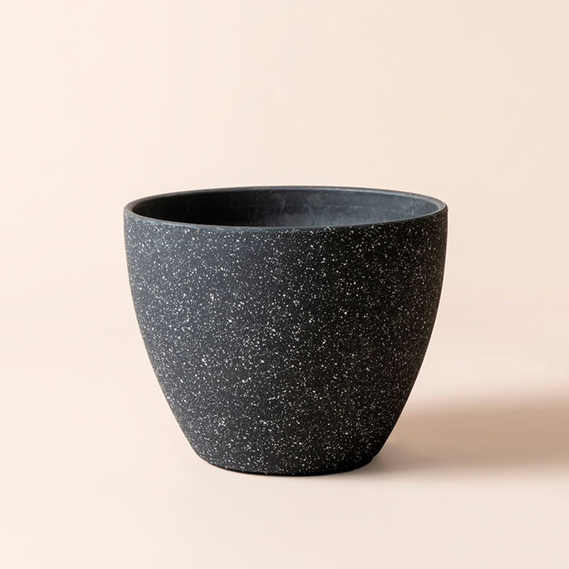 A complete view of a 8.6-inch pot in black, covered with a exterior speckled design.