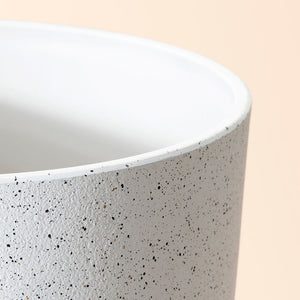 A close-up of the pot, showing its speckled feature and the pure white interior surface.