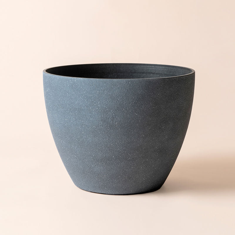 A full view of nova weathered gray pot, with grainy texture around the exterior. Showing its large dimension in 14.2 inches.