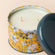 A close up of orange and bergamot candle, showing its double cotton wicks.