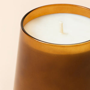 A close up of Spicy Amber candle, showing its cotton wick.