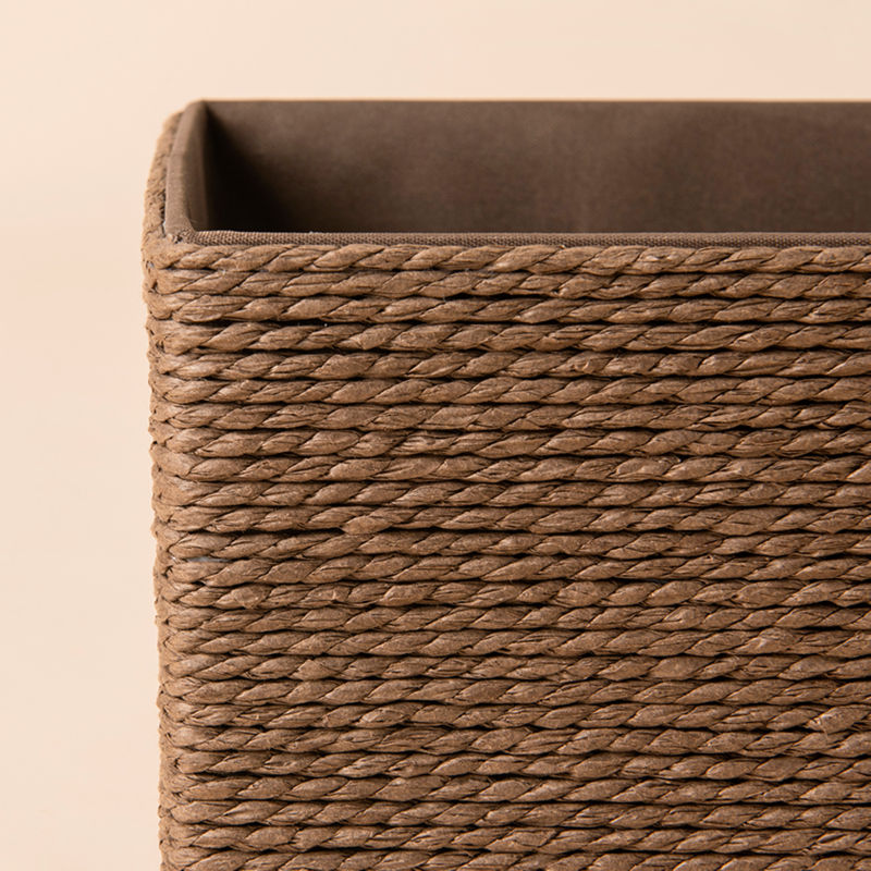 A close-up of Izar brown paper rope baskets, showing its hand-wrapped paper rope woven pattern and brown interior fabric.