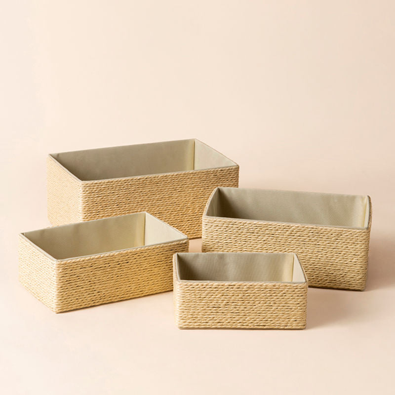 A full view of Izar cream paper rope baskets Set. Four different sizes of storage baskets stand in a staggered way.