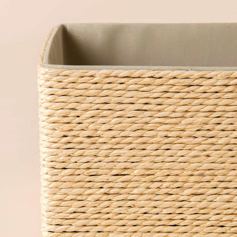 A close-up of Izar cream paper rope baskets, showing its hand-wrapped paper rope woven pattern and creamy interior fabric.