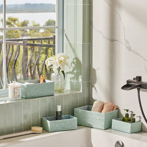 Mint storage baskets are placed next to a bathtub, fill up with bath towels and supplies. Decorate the bathroom with a refreshing style.\