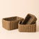 A full view of Kulu brown paper rope baskets Set. Three different sizes of storage baskets and are stacked.