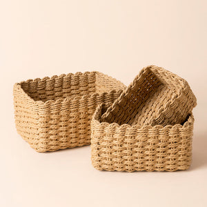 A set of three storage baskets made of sand paper ropes, placed in a staggered way.