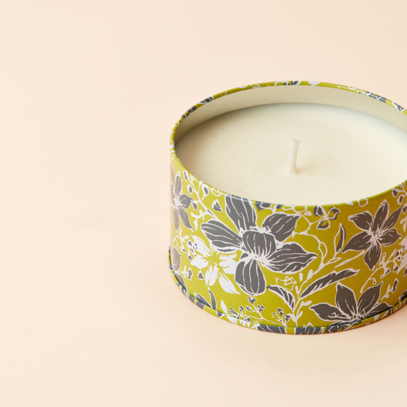 A close up of Peach and Kiwi Scented candle, showing its cotton wick.