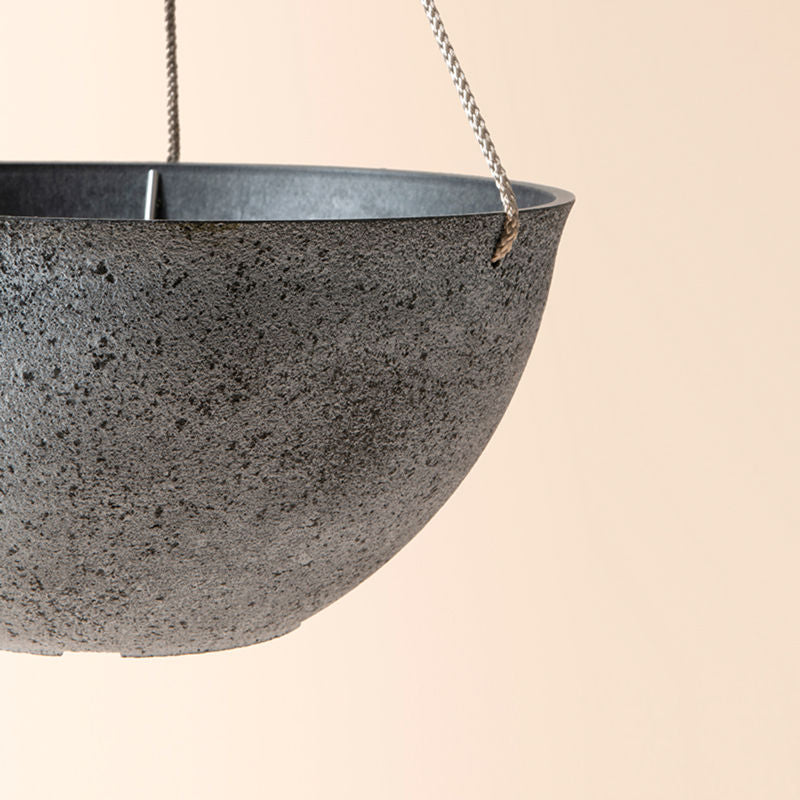 A close up of rock gray planter, showing its sturdy rope and sphere shape design.