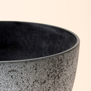 A close up of rock gray planter, showing its concrete texture and industrial look.