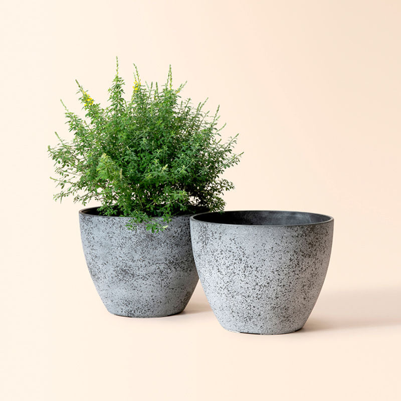 A set of two rock gray planter pots in same size, made from recyclable plastic and stone powders.