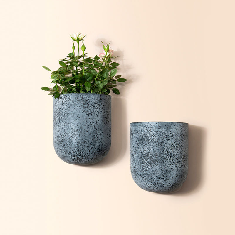 A set of two rock gray wall planters, made from recyclable plastic and natural stone powders.