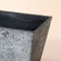 A close-up of the rock grey planter, showing its ceramic and gray finish design features.