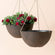 A set of two large hanging planters with rusty exterior, made from recyclable plastic and natural stone powders.