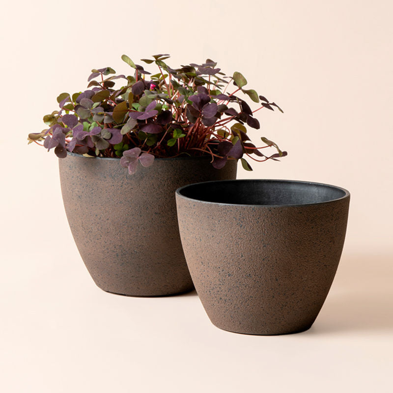 A set of two rusty outdoor planters in different dimensions, made from recyclable plastic and natural stone powders.
