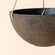 A close up of black hanging planter, showing its rusty exterior appearance and bowl shape design.