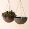 A set of two black hanging planters, made from recyclable plastic and natural stone powders.