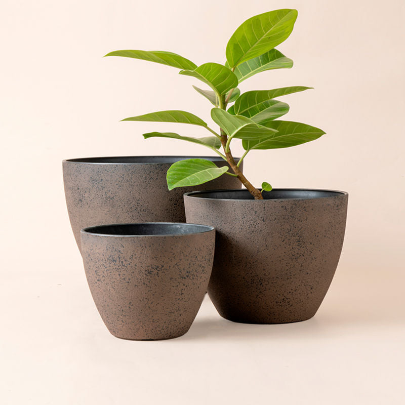 A set of three rusty planters in different dimensions, made from recyclable plastic and natural stone powders.