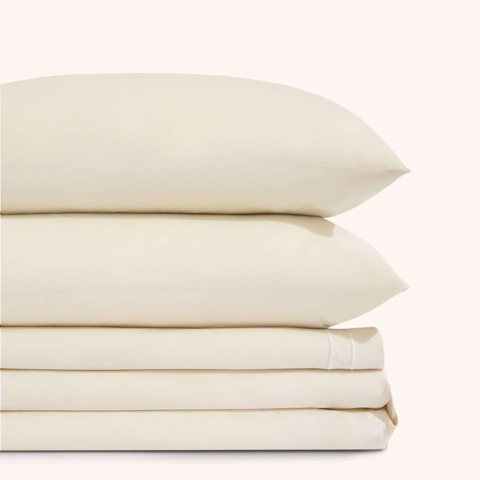 Sofia Ivory White Double Satin Stitched Cuff 300 thread count cotton bed sheet set. Two white pillows stacked on folded white sheet set.