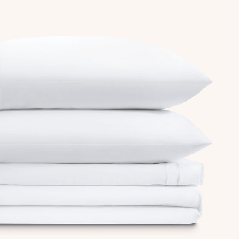 Sofia Classic White Double Satin Stitched Cuff 300 thread count cotton bed sheet set. Two white pillows stacked on folded white sheet set.