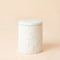Sandalwood-rose scented candle, in a white pottery jar which is covered with sculpted flowers reliefs. 