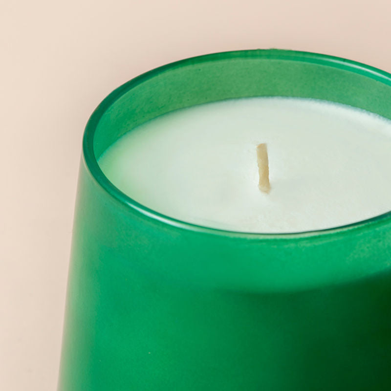 A close up of Balsam and Cedar candle, showing its cotton wick.