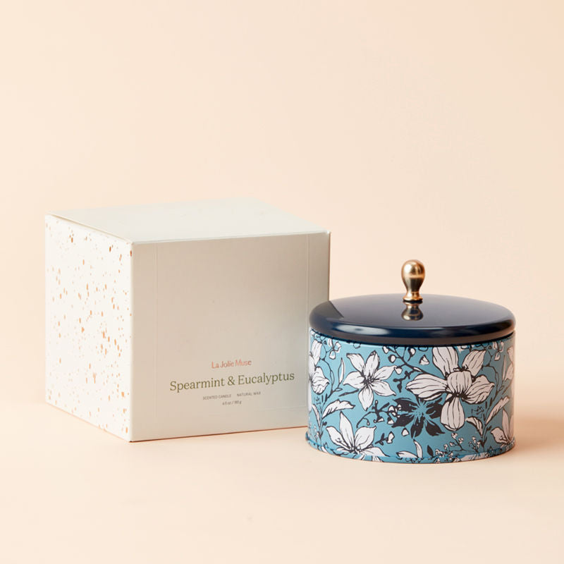 A tin of Spearmint and Eucalyptus candle and its white packing box.