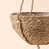 A close up of seagrass hanging pot, showing its woven texture and sturdy hanging rope.