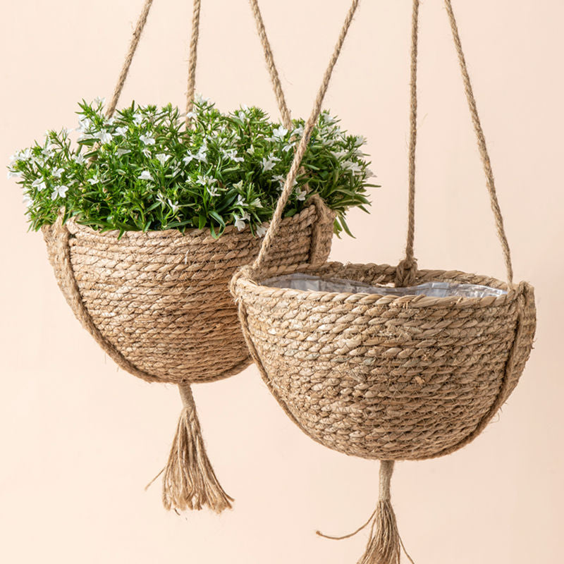 A pair of brown hanging planters, made of 100% premium seagrass with a interior plastic coating.
