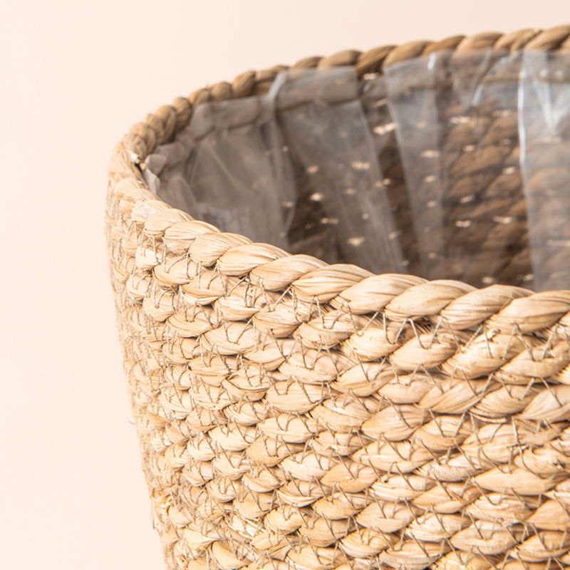 A close-up of the planter, showing the plastic coating inside the planter and its woven design.