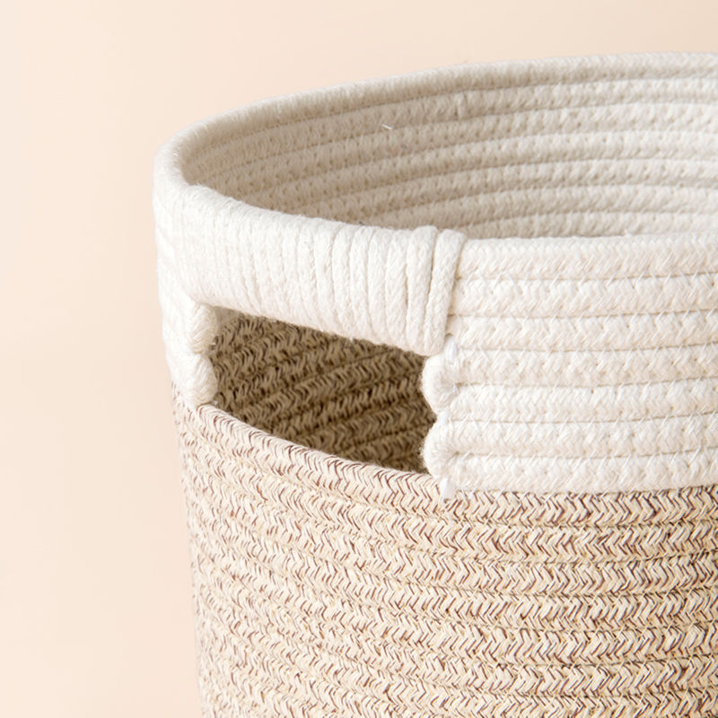 A close up of silky rope storage basket, showing its cotton texture and sturdy handle.