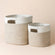 A set of two storage baskets in different sizes, made of silky white and beige cotton rope.