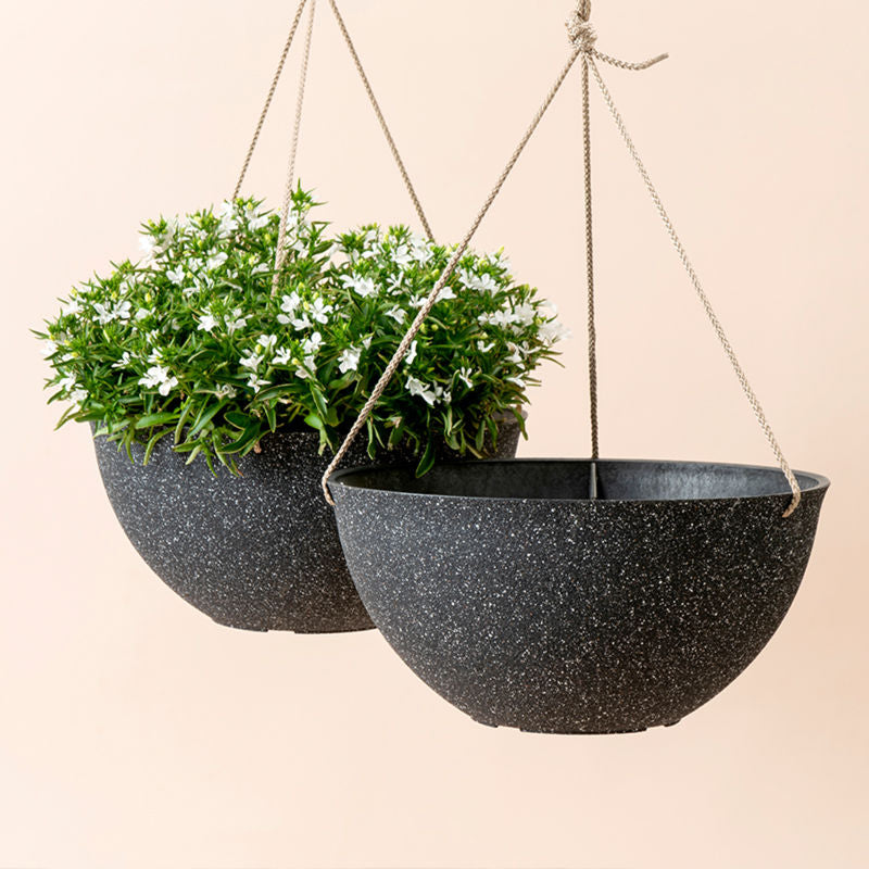 A set of two speckled black hanging pots in same sizes, made from recyclable plastic and natural stone powders.